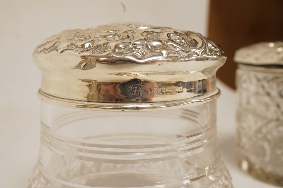 Six assorted silver lidded glass toilet jars including long rectangular, Birmingham, 1904, 22.9cm, together with a silver mounted hand mirror. Condition - poor